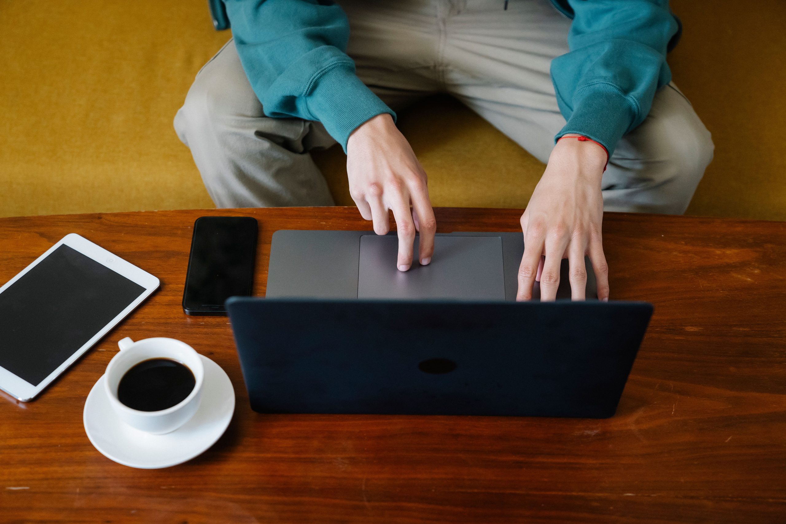 Freelance consultant son ordinateur avec café à proximité