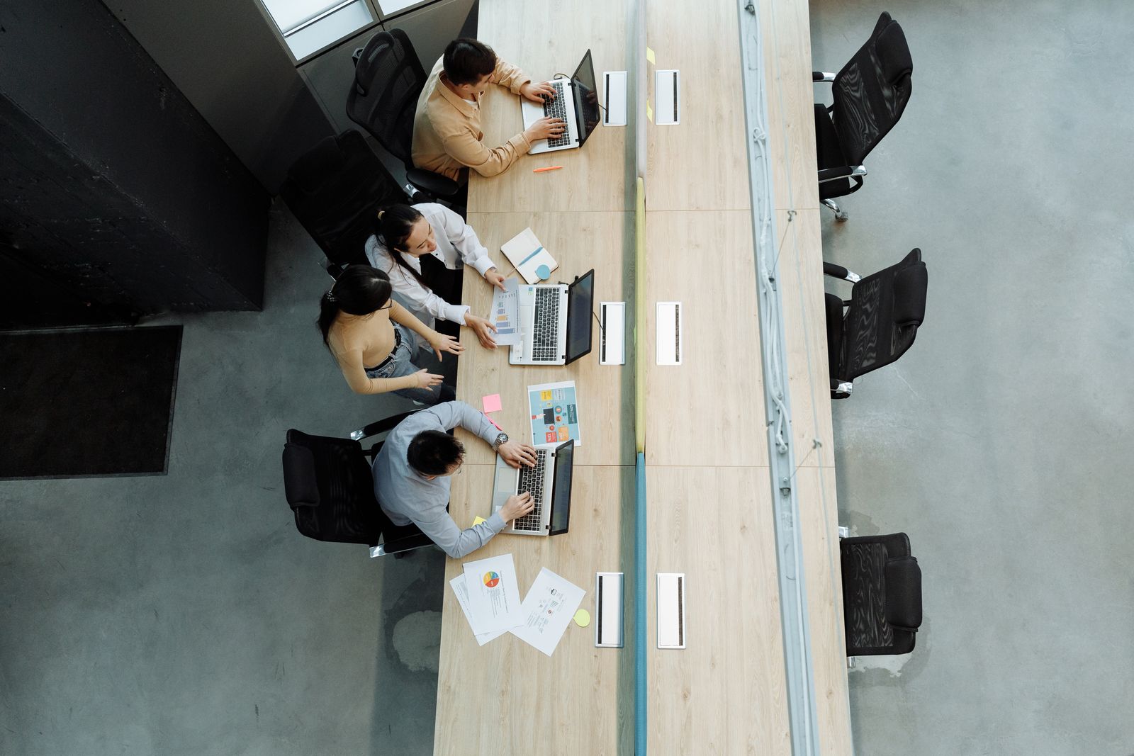 Indépendants au travail le long d’une table partagée, vus d’en haut